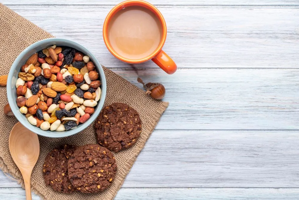 top-view-mix-nuts-dried-fruits-bowl-oatmeal-cookies-with-mug-cocoa-drink-rustic.jpg?format=webp